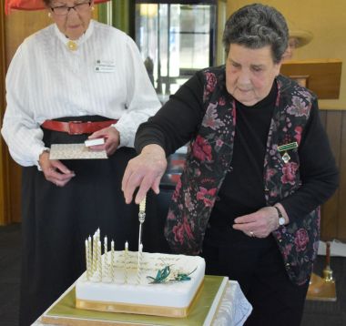 Iris Williams cutting the cake
